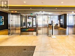 Toronto (Church-Yonge Corridor) condo for rent - A hallway with a sign that says "HOMELIFE/MIRACLE REALTY LTD, Brokerage" on the wall.