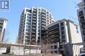 Markham (Unionville) condo for rent - A tall residential building with a clear blue sky in the background.