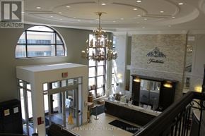 Markham (Unionville) condo for rent - A large, well-lit lobby with a chandelier and a reception desk.