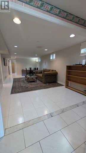 Mississauga (Erin Mills) apartment for rent - A living room with a couch, a rug, and a wooden bookcase.