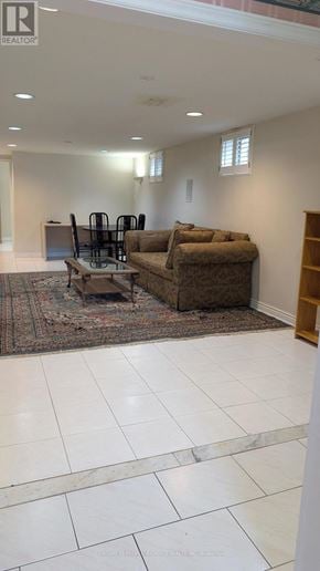 Mississauga (Erin Mills) apartment for rent - A living room with a brown couch and a rug.