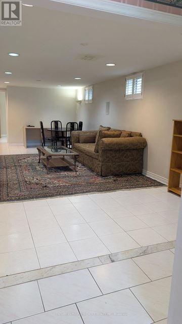 Mississauga (Erin Mills) apartment for rent - A living room with a brown couch and a rug.