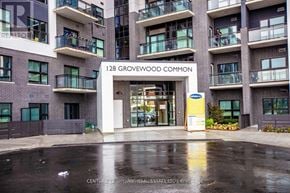 Oakville (Oa Rural Oakville) condo for rent - The entrance to 128 Grovewood Common is shown with a wet ground.