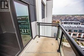 Oakville (Oa Rural Oakville) condo for rent - A balcony with a glass door and a metal railing.