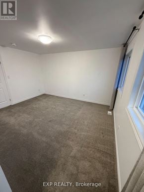 Welland (N. Welland) apartment for rent - A room with a carpeted floor and a window with blue curtains.
