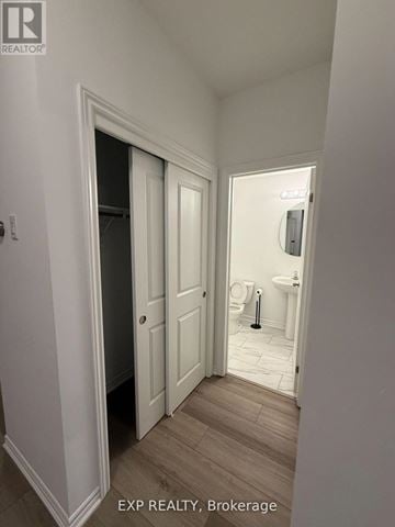 Welland (N. Welland) apartment for rent - A hallway with a door on the left and a bathroom on the right.