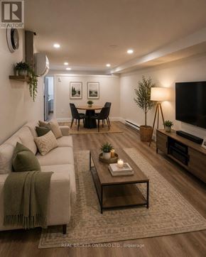 Toronto (Oakwood Village) duplex for rent - A room with wooden flooring and a white wall with a Real Broker logo.