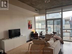 Toronto (Kensington-Chinatown) condo for rent - A living room with a flat screen TV and a large window.