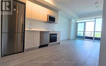 Toronto (Clairlea-Birchmount) condo for rent - A modern kitchen with wooden cabinets and a stainless steel refrigerator.