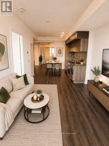 Mississauga (City Centre) condo for rent - A modern living room with a white sofa and a coffee table.