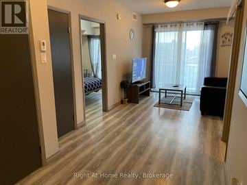 Waterloo condo for rent - A living room with a television and a couch.