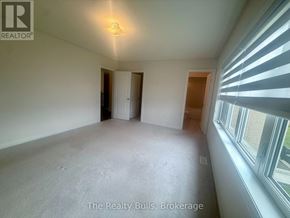 Melancthon apartment for rent - A room with a window on the right side and a door on the left side.