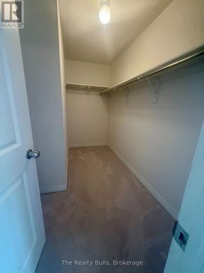 Melancthon apartment for rent - A hallway with a door on the left and a light on the ceiling.