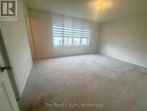 Melancthon apartment for rent - A room with a carpeted floor, a window with blinds, and a door.