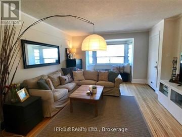 Toronto (Lawrence Park South) condo for rent - A living room with a large sectional sofa and a coffee table.