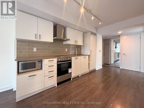 Toronto (Mount Pleasant West) condo for rent - A kitchen with white cabinets and a microwave above the oven.