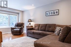 Stratford townhouse for rent - A living room with brown furniture and a large window.