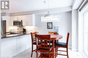 Stratford townhouse for rent - A kitchen with a table and chairs in the middle of it.