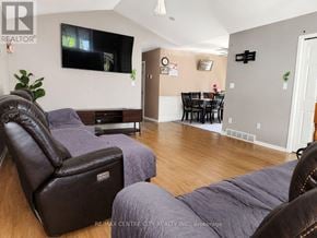Stratford townhouse for rent - A living room with a flat screen TV mounted on the wall.