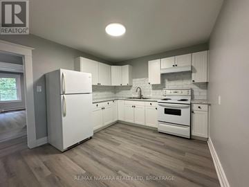 St. Catharines (Downtown) apartment for rent - A kitchen with white appliances and cabinets.
