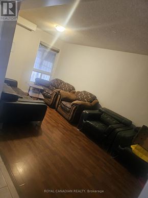 Brampton (Fletcher's Creek South) apartment for rent - A living room with a couch and a chair.