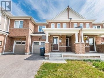Brampton (Northwest Brampton) townhouse for rent - A large brick house with a covered front porch.