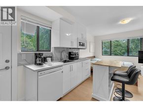 North Vancouver apartment for rent - A white kitchen with a black bar stool.