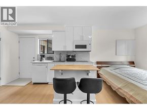 North Vancouver apartment for rent - A bedroom with a bed, desk, and chair.
