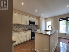 Oakville (Ro River Oaks) apartment for rent - A kitchen with a granite countertop and white cabinets.
