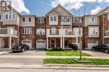 Milton (Ha Harrison) townhouse for rent - A row of townhouses with garages and cars parked in front.
