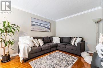 Milton (Ha Harrison) townhouse for rent - A living room with a grey couch and a rug.