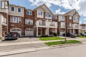 Milton (Ha Harrison) townhouse for rent - A building with a car parked in front of it.