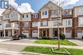 Milton (Ha Harrison) townhouse for rent - A large, multi-story residential building with a car parked in front.