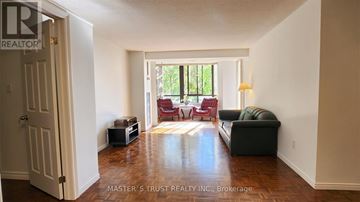 Toronto (Kensington-Chinatown) condo for rent - A living room with a couch, chairs, and a television set.