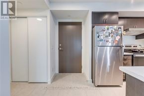 Toronto (Weston) condo for rent - A kitchen with a refrigerator covered in magnets.