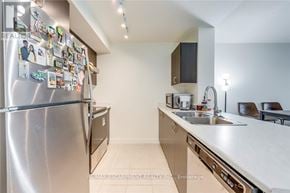 Toronto (Weston) condo for rent - A kitchen with a refrigerator covered in magnets.