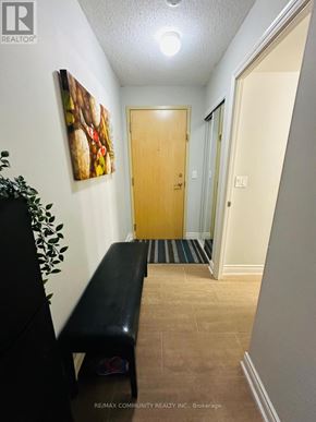 Toronto (Bendale) condo for rent - A hallway with a bench and a door.