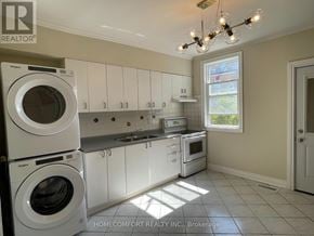 Toronto (Weston-Pellam Park) apartment for rent - A white laundry room with a washer and dryer stacked on top of each other.