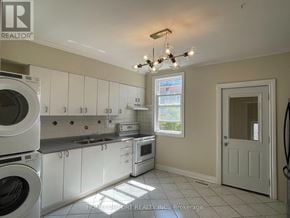Toronto (Weston-Pellam Park) apartment for rent - A sunny kitchen with white appliances and cabinets.