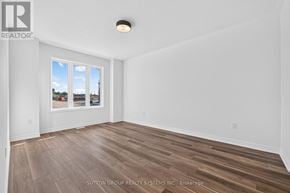 Oakville (Jm Joshua Meadows) townhouse for rent - A room with a window showing a view of a street and houses.