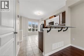 Grimsby townhouse for rent - A well-lit kitchen with white cabinets and a wooden countertop.