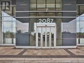Burlington (Freeman) condo for rent - The image shows the front of a building with a glass door and the number 2087 on it.