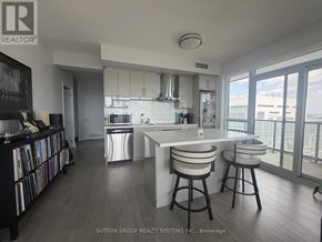 Burlington (Freeman) condo for rent - A modern kitchen with a bar stool and a view of the city.