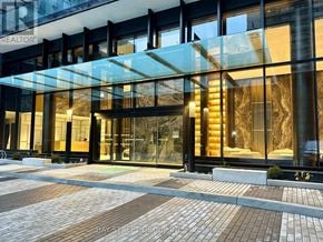 Toronto (Mount Pleasant West) condo for rent - A modern building with a glass entrance and a sign that says "REALTOR".