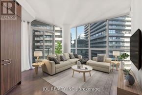 Toronto (Church-Yonge Corridor) condo for rent - A modern living room with a large window and a flat screen TV.