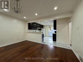 Toronto (Bendale) apartment for rent - A spacious room with wooden floors and a chandelier.