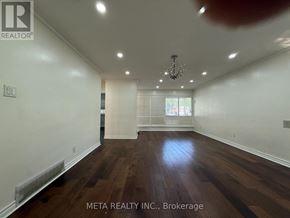 Toronto (Bendale) apartment for rent - A room with wooden floors and white walls, with a chandelier hanging from the ceiling.