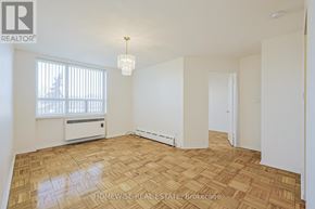 Toronto (The Beaches) multi-family for rent - A room with a wooden floor and a window with blinds.