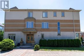 Richmond Hill (Langstaff) apartment for rent - A large, two-story house with a front porch and a small garden.
