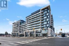 Vaughan (Uplands) condo for rent - A modern multi-story building with a glass facade is the main focus of the image.